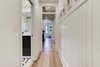Modern home with Hallway and Light Hardwood Floor. A peek down the hallway and a glimpse of our black DIY shaker doors Photo 12 of Denver Home