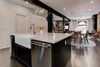 Modern home with Kitchen, Ceiling Lighting, Recessed Lighting, Dishwasher, Undermount Sink, Marble Counter, Pendant Lighting, and Dark Hardwood Floor. The open floor plan lets the space transition from kitchen to dining area. Photo 3 of Denver Home