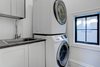 Modern home with Laundry Room, Stacked, and White Cabinet. A closeup of DIY shaker cabinets in the laundry room. Photo 10 of Denver Home