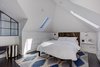 Modern home with Bedroom, Dark Hardwood Floor, Shelves, Chair, Night Stands, Recessed Lighting, Ceiling Lighting, and Bed. Skylights added during the remodel let in plenty of natural light. Photo 16 of Denver Home