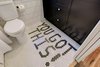 Modern home with Bath Room, Ceramic Tile Floor, One Piece Toilet, Ceramic Tile Wall, and Subway Tile Wall. A view of the bottom of our cabinet faces and a motivational tile floor. Photo 14 of Denver Home