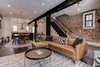Modern home with Living Room, Ceiling Lighting, Dark Hardwood Floor, Coffee Tables, Pendant Lighting, Recessed Lighting, and Sectional. Another view of the open floor plan on the first floor. Photo 7 of Denver Home