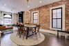 Modern home with Dining Room, Table, Standard Layout Fireplace, Dark Hardwood Floor, Recessed Lighting, Chair, Ceiling Lighting, Wood Burning Fireplace, and Pendant Lighting. Lots of natural light gives the living space/kitchen area an open, airy feel. Photo 9 of Denver Home