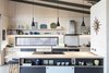 Modern home with Kitchen, Ceiling Lighting, Laminate Counter, Cooktops, Concrete Floor, Pendant Lighting, Laminate Cabinet, Track Lighting, Drop In Sink, Range, and Brick Backsplashe. Kitchen Photo 20 of The Golf Course House
