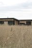 Modern home with Exterior, Metal Roof Material, Wood Siding Material, Shed RoofLine, and House Building Type. View From Golf Course Photo of The Golf Course House