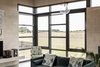 Modern home with Living Room, Bench, Pendant Lighting, Sofa, Chair, Concrete Floor, and Ceiling Lighting. Living room Photo 7 of The Golf Course House