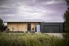 Modern home with Exterior, Flat RoofLine, Metal Roof Material, Shed RoofLine, House Building Type, and Wood Siding Material. View from Street Photo 2 of The Golf Course House