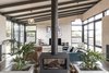 Modern home with Living Room, Ceiling Lighting, Chair, Concrete Floor, Two-Sided Fireplace, Wood Burning Fireplace, Pendant Lighting, Sofa, and Coffee Tables. Living Photo 19 of The Golf Course House
