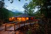 Modern home with Outdoor, Front Yard, Large Patio, Porch, Deck, Trees, Walkways, Wood Patio, Porch, Deck, and Decking Patio, Porch, Deck. Exterior Photo of A Deltec Tree House