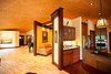 Modern home with Kitchen, Granite Counter, Wood Cabinet, Ceiling Lighting, Light Hardwood Floor, Recessed Lighting, Refrigerator, and Wall Oven. The kitchen and seating area Photo 8 of A Deltec Tree House
