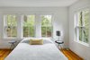 Modern home with Bedroom, Bed, Night Stands, Table Lighting, and Medium Hardwood Floor. The Downstairs at The Bracy House Photo 5 of The Bracy House