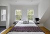 Modern home with Bedroom, Night Stands, Bed, Table Lighting, and Medium Hardwood Floor. The Upstairs at The Bracy House Photo 10 of The Bracy House