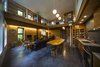 Modern home with Dining Room, Table, Pendant Lighting, Wood Burning Fireplace, and Concrete Floor. Open living with offices at balcony Photo 3 of Basecamp Home