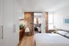 Modern home with Bedroom, Bed, Dresser, Night Stands, Ceiling Lighting, Accent Lighting, Medium Hardwood Floor, and Light Hardwood Floor. Master bedroom with ensuite beyond Photo 10 of House Grace
