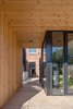 Modern home with Exterior, Wood Siding Material, Metal Siding Material, Brick Siding Material, and House Building Type. Rear portico framing rear access to house Photo 18 of House Grace