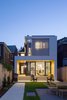 Modern home with Exterior, House Building Type, Flat RoofLine, Wood Siding Material, and Concrete Siding Material. New addition at rear of house framing the original house and interior areas Photo of House Grace