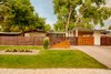 From the street, large trees provide shade to the private courtyard in the summer. A unique remote-controlled gate has been added to the house’s original carport. A new address monument matches the angle of the house’s roof. Photo of Cliff May Homes RM 3212 modern home