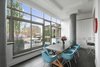 Modern home with Dining Room, Chair, Recessed Lighting, Stools, Dark Hardwood Floor, and Table. West Village Terrace Photo of Eames Molded Chairs