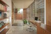 Modern home with Chair and Concrete Floor. ANACAPA Architecture designed Minimalist Urban Residence with California's temperate climate in mind. Radiant heat cement floors that extend into the study keep the home warm on cooler days. Photo 12 of Minimalist Urban Residence