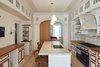 Kitchen designed by architect Louis Mackall. Cabinet fabrication by James Schriber Furniture. Tile backsplash by Mosaic House in NY, specializing in Moroccan Tiles.
Architect Louis Mackall designed two archways, with custom arched pocket doors from Breakfast Woodworks for the parlor opening. Photo 7 of Carroll Gardens Passive House modern home