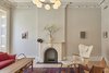 Parlor: A Vilhelm Lauritzen hangs above a Vintage Moroccan rug from Breuckelen Berber. A Finn Juhl Chieftain Chair alongside a Mama Bear Chair; reupholstered and paired with a matching ottoman in Hella Jongerius fabric sit next to a Hans Wegner coffee table.
Ceiling decoration is original – parts of it replicated by Absolute Plastering in Brooklyn. Photo 6 of Carroll Gardens Passive House modern home