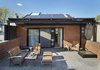 Modern home with Doors, Exterior, Metal, Wood, and Sliding Door Type. A 387-square-foot Brooklyn Solarworks solar canopy to help offset the home’s energy needs. Photo 14 of First Passive House Plus in the U.S.