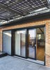 Modern home with Doors, Metal, Exterior, Sliding Door Type, and Wood. A 387-square-foot Brooklyn Solarworks solar canopy to help offset the home’s energy needs. Photo 15 of First Passive House Plus in the U.S.