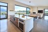 Modern home with Doors, Interior, Wood, Sliding Door Type, Metal, and Exterior. Just off the kitchen, “window walls” of Zola Windows enormous 24-foot triple Zola Lift & Slide door and large fixed units of 8-foot by 10-foot windows–with a custom matte metallic gray. Photo 2 of House of Fir