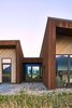 Modern home with Doors, Metal, Interior, Wood, Exterior, and Swing Door Type. The sloping winged walls have mitered corners and nails laid out in perfect dimensions. Photo 11 of House of Fir