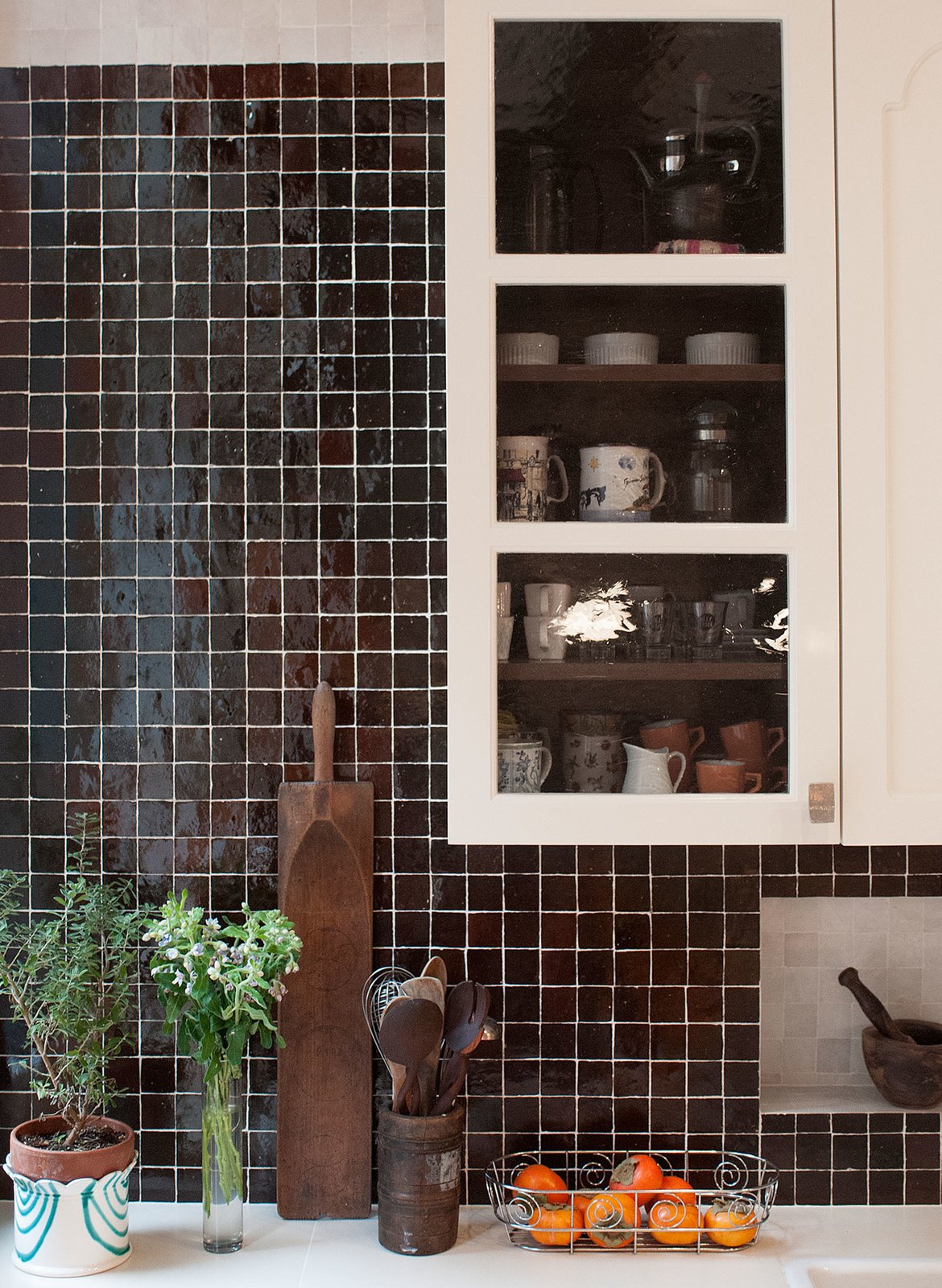 Hand-made Moroccan tile backsplash by Mosaic House with contrasting niche; custom kitchen cabinets designed by MIRIAM BIOLEK Interior Design with Bendheim's mouth-blown glass inserts.