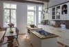 Modern home with Kitchen, Medium Hardwood Floor, Refrigerator, Cooktops, Mosaic Tile Backsplashe, White Cabinet, Dishwasher, Wood Counter, Track Lighting, Wall Oven, Pendant Lighting, and Ceiling Lighting. Custom-designed Brownstone Kitchen. Photo 4 of Harlem Brownstone