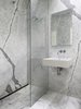 View of the Powder Room, which also doubles as the Guest Bathroom. The same stone as used in the Kitchen is used the Bathrooms for continuity. The wall hung lavatory is by Duravit, the medicine cabinet with integral lighting is by Sidler and all fixtures are by Vola. Photo 14 of Telegraph Hill Periscope modern home