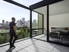 View of the San Francisco skyline from the Roof Deck and Sun Room. The same colored concrete pavers are used in both spaces to blur the relationship between the indoors and outdoors. The owners selected the 1966 collection of outdoor furniture by Knoll which contributes to this effect. Photo 2 of Telegraph Hill Periscope modern home