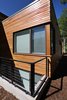 Cedar rain screen and metal guardrail at light well Photo 9 of Higgins Lake House modern home