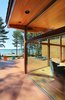 Southwest corner showing relationship between wrap around deck and interior Photo 8 of Higgins Lake House modern home