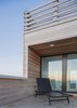 Modern home with Outdoor, Rooftop, Wood Patio, Porch, Deck, Horizontal Fences, Wall, Decking Patio, Porch, Deck, and Wood Fences, Wall. Riverside deck looking through house to ocean at dusk Photo 16 of Sea Bright House