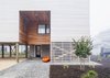 Modern home with Exterior, House Building Type, Beach House Building Type, Flat RoofLine, and Wood Siding Material. Entryway and screened gear enclosure Photo of Sea Bright House