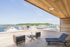 Modern home with Outdoor, Rooftop, Wood Patio, Porch, Deck, Decking Patio, Porch, Deck, Horizontal Fences, Wall, and Wood Fences, Wall. Riverside deck Photo 17 of Sea Bright House