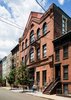 Modern home with Outdoor, Front Yard, Trees, Vertical Fences, Wall, and Metal Fences, Wall. Existing historic facade of loft building Photo 2 of Wells Fargo Loft