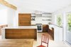 Modern home with Kitchen, Refrigerator, Range, Range Hood, Marble Counter, Wood Cabinet, Medium Hardwood Floor, Ceramic Tile Backsplashe, Dishwasher, Ceiling Lighting, Track Lighting, and Undermount Sink. Dining room and kitchen Photo 7 of Deertrack Lane