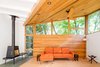 Modern home with Living Room, Sofa, Coffee Tables, Ceiling Lighting, Recessed Lighting, Floor Lighting, Medium Hardwood Floor, and Wood Burning Fireplace. Living room addition with new roof and windows Photo 8 of Deertrack Lane