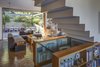 Modern home with Living Room, Sofa, Coffee Tables, Chair, Bookcase, Ceiling Lighting, Pendant Lighting, and Medium Hardwood Floor. Living Room Photo 11 of NHN House