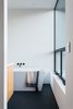 Modern home with Bath Room, Porcelain Tile Floor, Engineered Quartz Counter, and Freestanding Tub. Master Bathroom Photo 10 of Tilt-Shift House