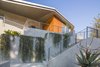 Modern home with Exterior, House Building Type, Metal Roof Material, Wood Siding Material, Metal Siding Material, Stucco Siding Material, and Butterfly RoofLine. Exterior Entry Photo 6 of View House