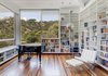Modern home with Living Room, Ottomans, Chair, Bookcase, Pendant Lighting, Ceiling Lighting, and Medium Hardwood Floor. Living Room Photo 9 of View House