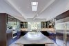 Modern home with Kitchen, Refrigerator, Wall Oven, Cooktops, Range Hood, Metal Counter, Concrete Counter, Wood Cabinet, Porcelain Tile Floor, Metal Backsplashe, and Recessed Lighting. Kitchen Photo 15 of View House