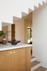 Modern home with Kitchen, Wood Cabinet, Engineered Quartz Counter, Medium Hardwood Floor, Recessed Lighting, and Ceiling Lighting. View to Entry Photo 8 of SL House