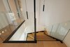 Modern home with Staircase, Glass Railing, Wood Tread, and Metal Tread. staircase details Photo 19 of CK House