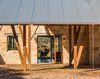 Modern home with Doors, Exterior, Swing Door Type, and Sliding Door Type. The porte cochère is the main entry to the house. A mahogany-and-glass pivot door allows you to see through the Great Room to the back porch and the valley beyond. Photo of The Goat Sheds