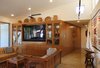 The built-in cabinetry showcases some of the owner's extensive Native American collection and wraps around the corner as a paneled wall with hidden doors that lead to a half bath and a small office. Stained concrete floors. Photo 9 of The Goat Sheds modern home